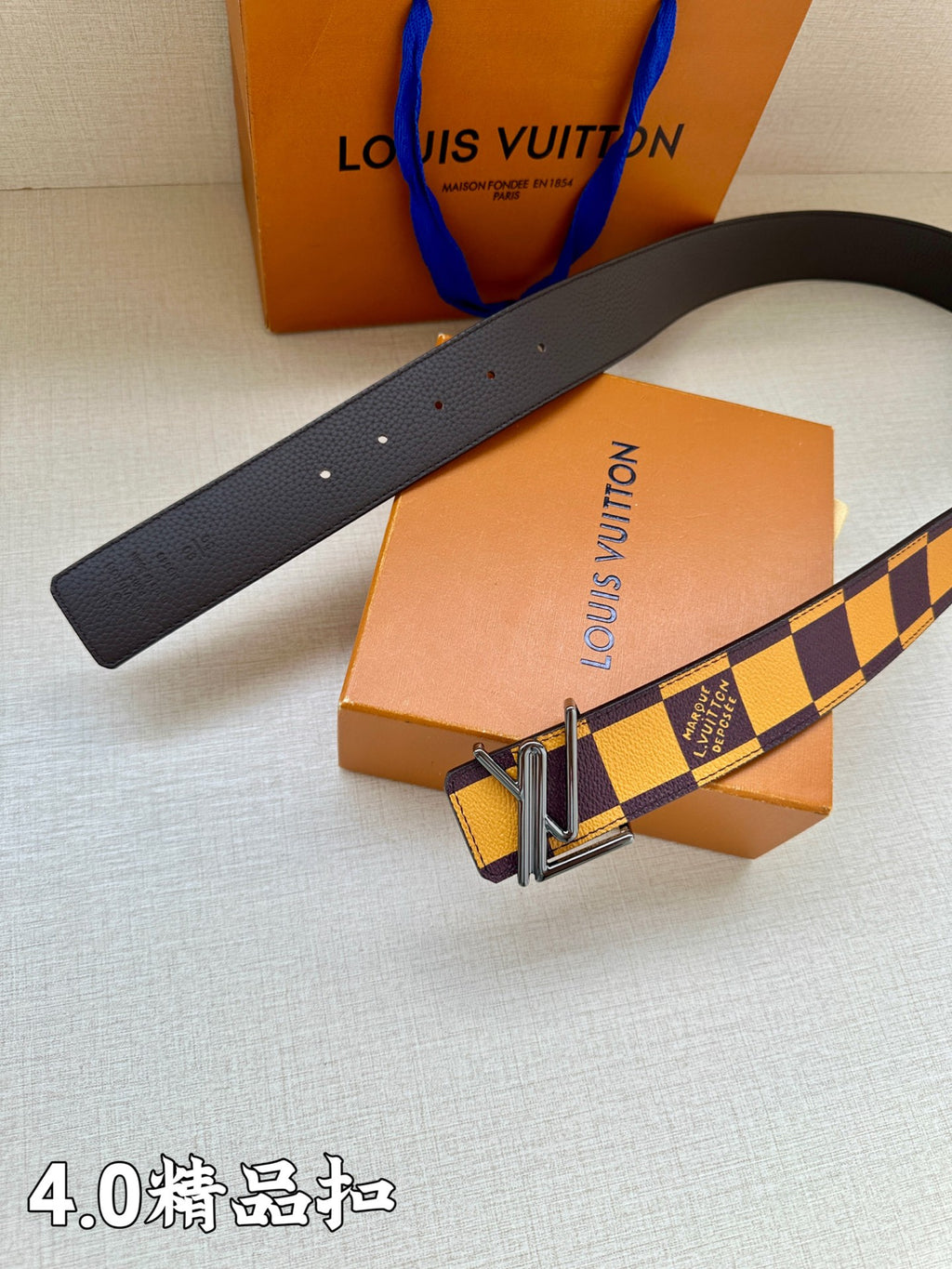 Louis Vuitton belt with smooth dark strap end and Damier check section with gold buckle