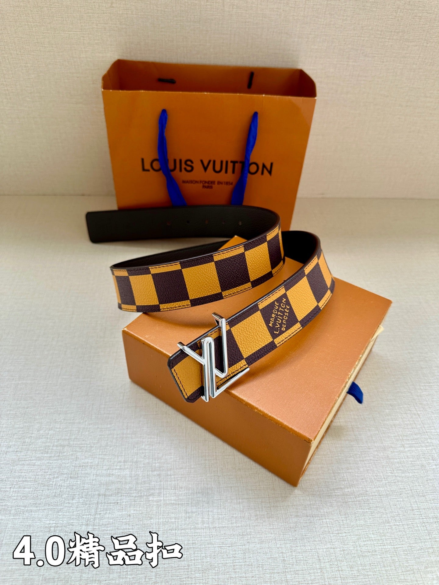 Louis Vuitton Damier check belt with gold buckle and dark-and-yellow strap on boxes