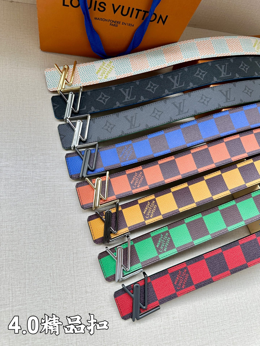 Set of multicolor checkered leather belts with metal buckles