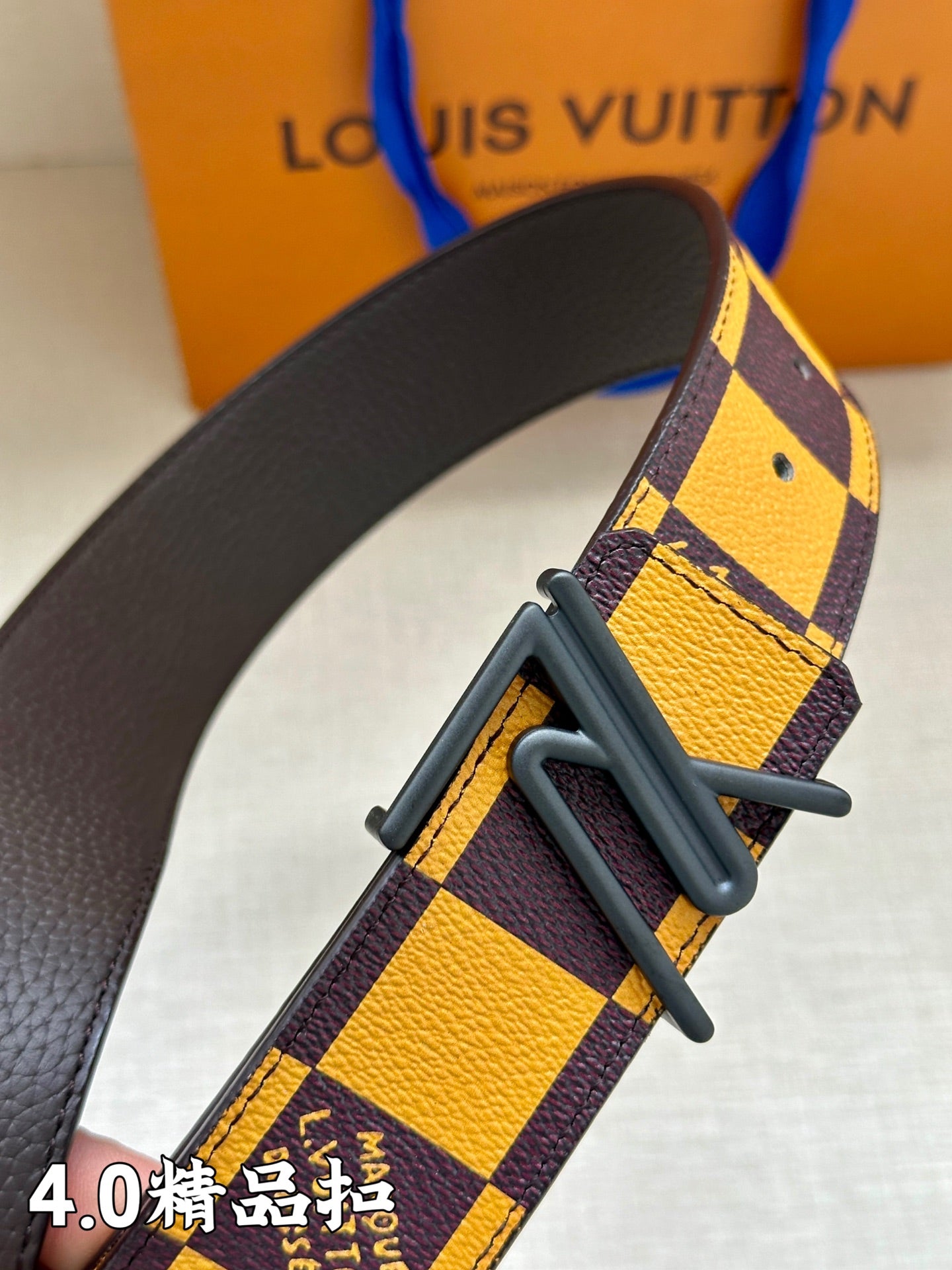 Checkered belt strap with metal buckle detail, close-up