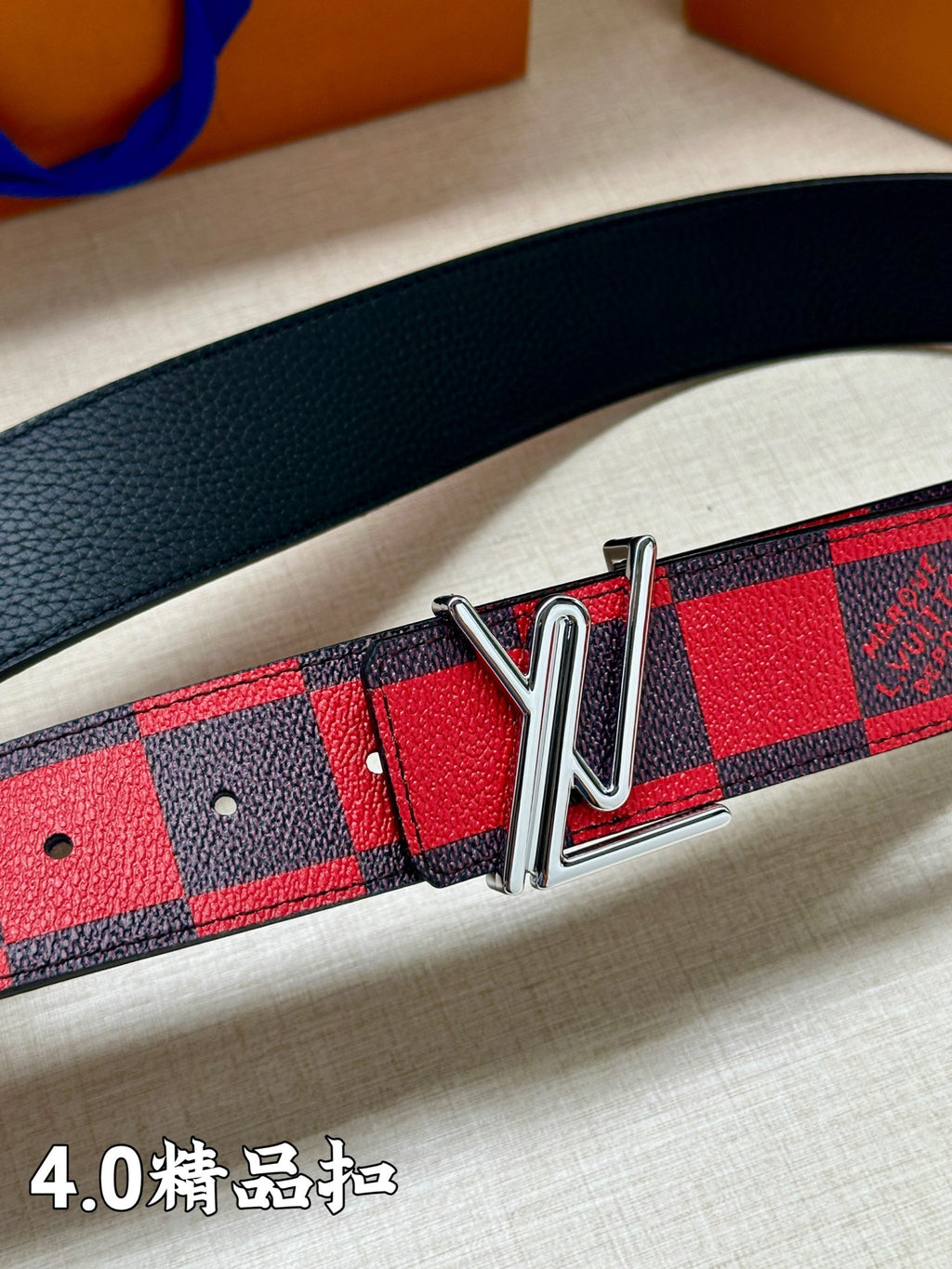Checked belt close-up with red and blue pattern and silver-tone buckle