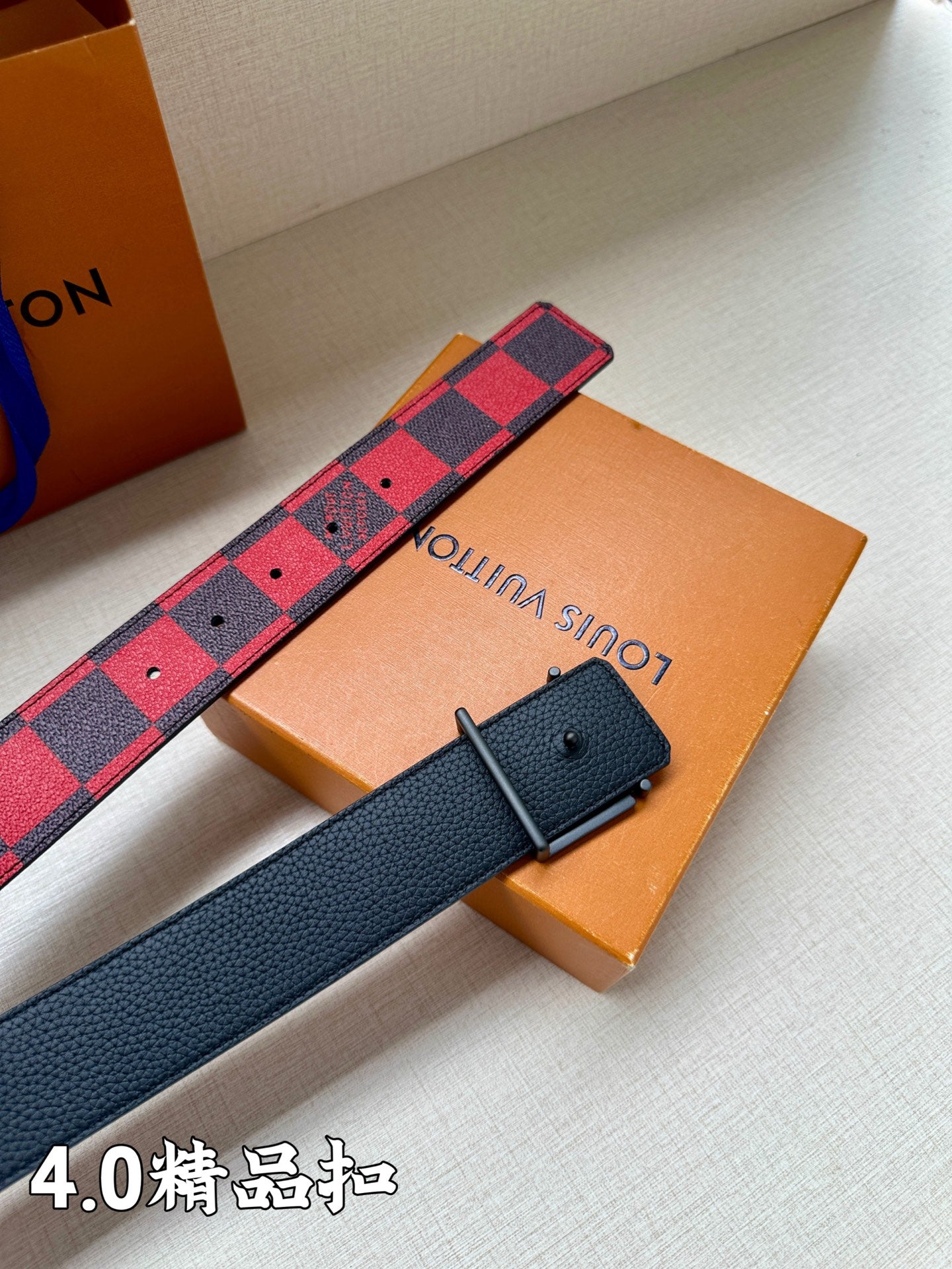 Red and navy check belt with dark blue keeper and black buckle