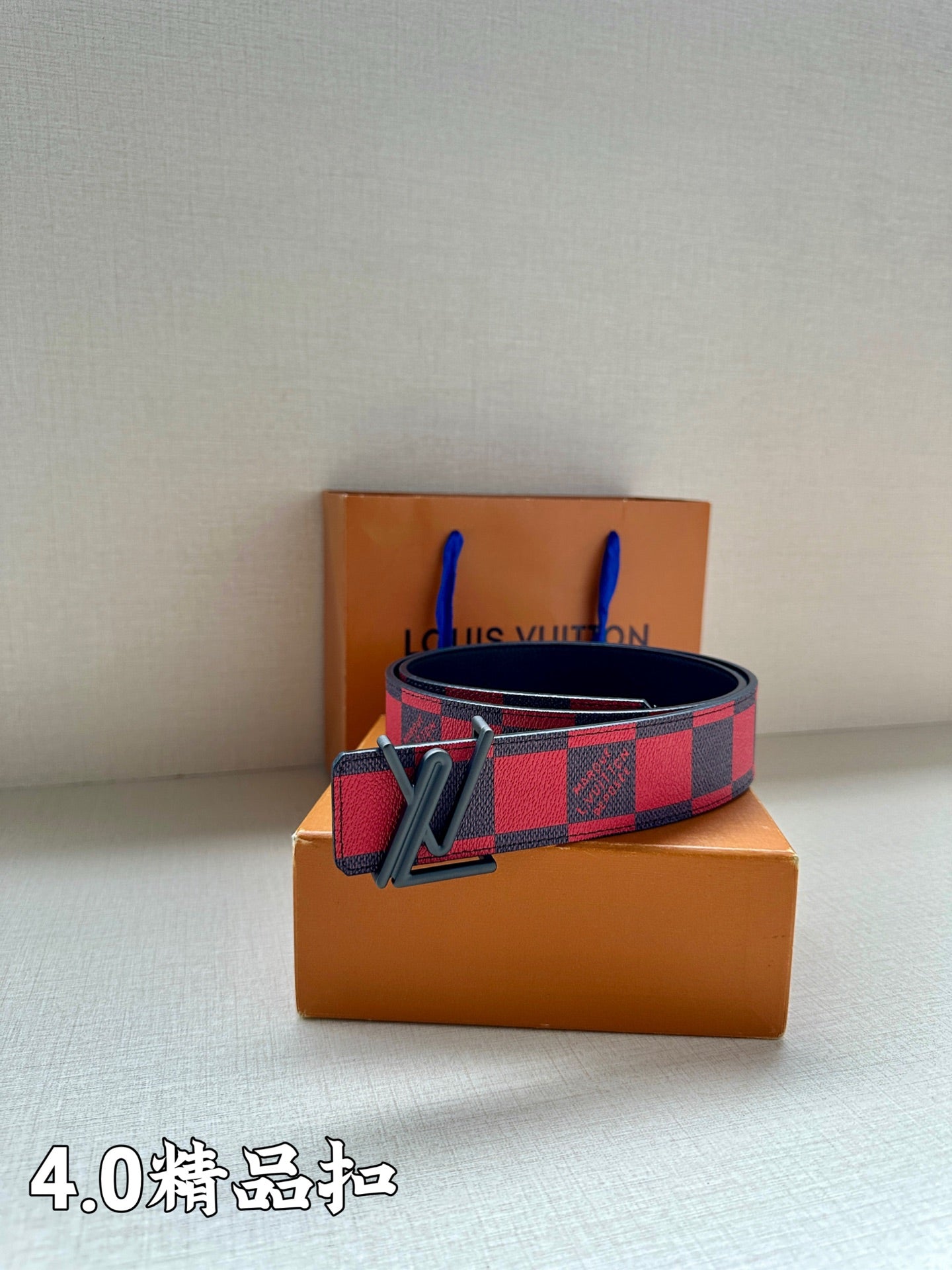 Check belt with black buckle on dark blue strap, red and navy grid