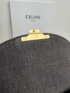Gray Celine handbag back view with gold bar clasp hardware and snaps.