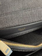Gray Celine handbag interior zipper with gold track and logo patch.