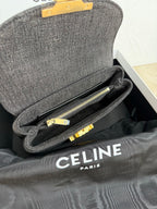 Gray Celine handbag open with interior zipper pocket and gold hardware.