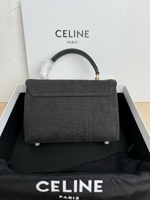 Gray Celine handbag with top handle and flap, gold clasp, short feet detail.