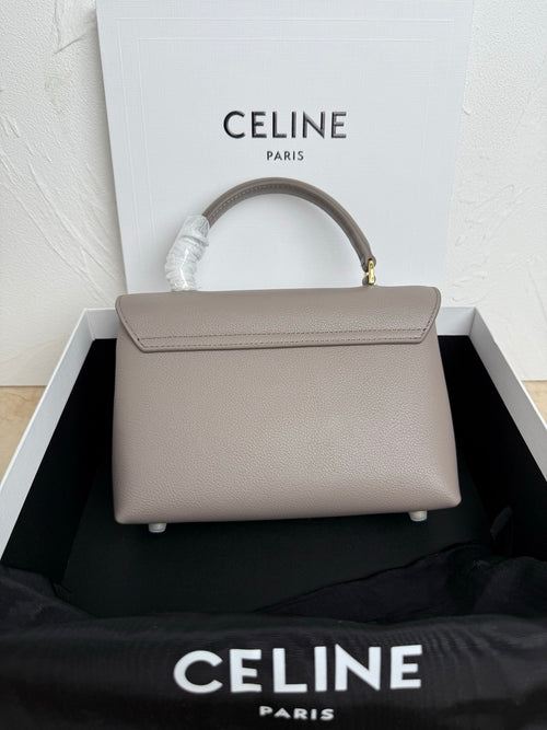 Celine structured top-handle bag in taupe with flap closure and gold hardware
