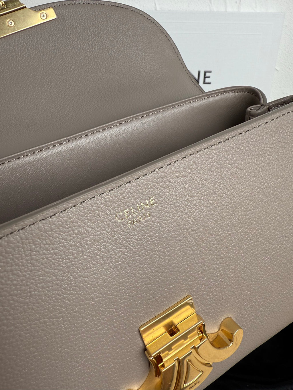 Celine taupe bag interior lining and gold-tone clasp on close-up
