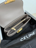 Celine taupe mini bag open view with internal compartment and gold zipper pull