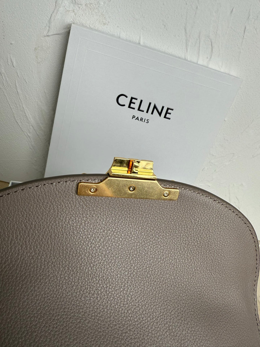Celine taupe top edge hardware with gold latch and stud accents