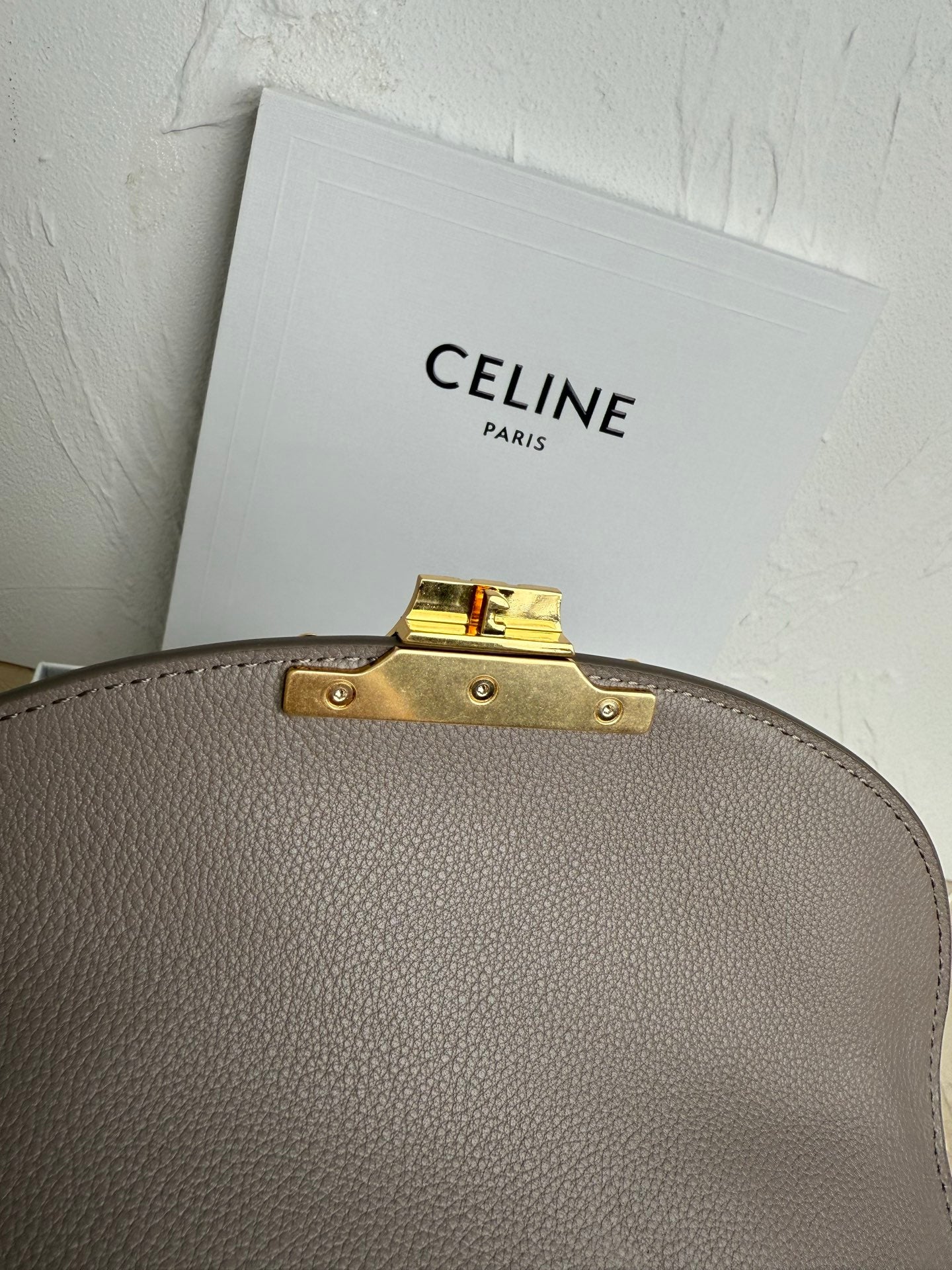 Celine taupe top edge hardware with gold latch and stud accents
