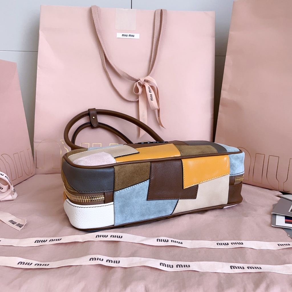 MiuMiu patchwork leather top-handle bag with ribbon tag and gold-toned zipper