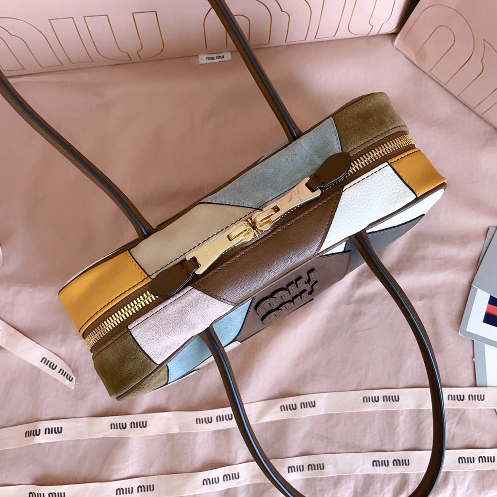 MiuMiu patchwork leather handbag with gold zipper end and green, yellow, and blue blocks