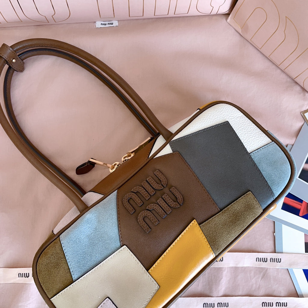 MiuMiu patchwork leather handbag detail view with embossed logo panel and gold hardware
