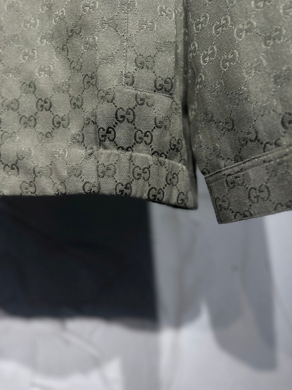 Gucci-pattern jacket hem and cuff detail with dark trim