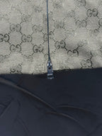 Gucci-pattern jacket zipper close-up with textured fabric