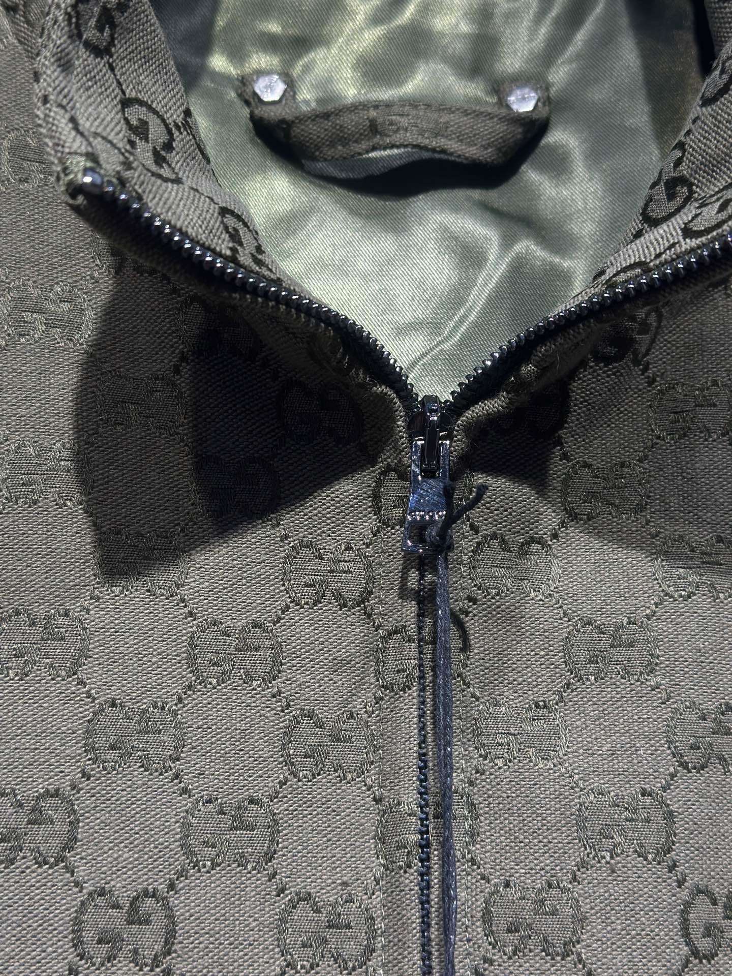 Gucci-pattern zip jacket front with exposed zipper and dark trim