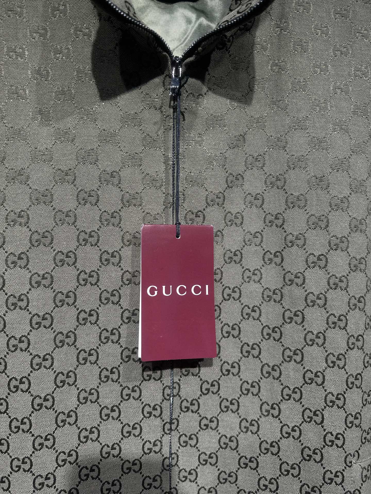 Gucci-pattern zip jacket with hanging brand tag