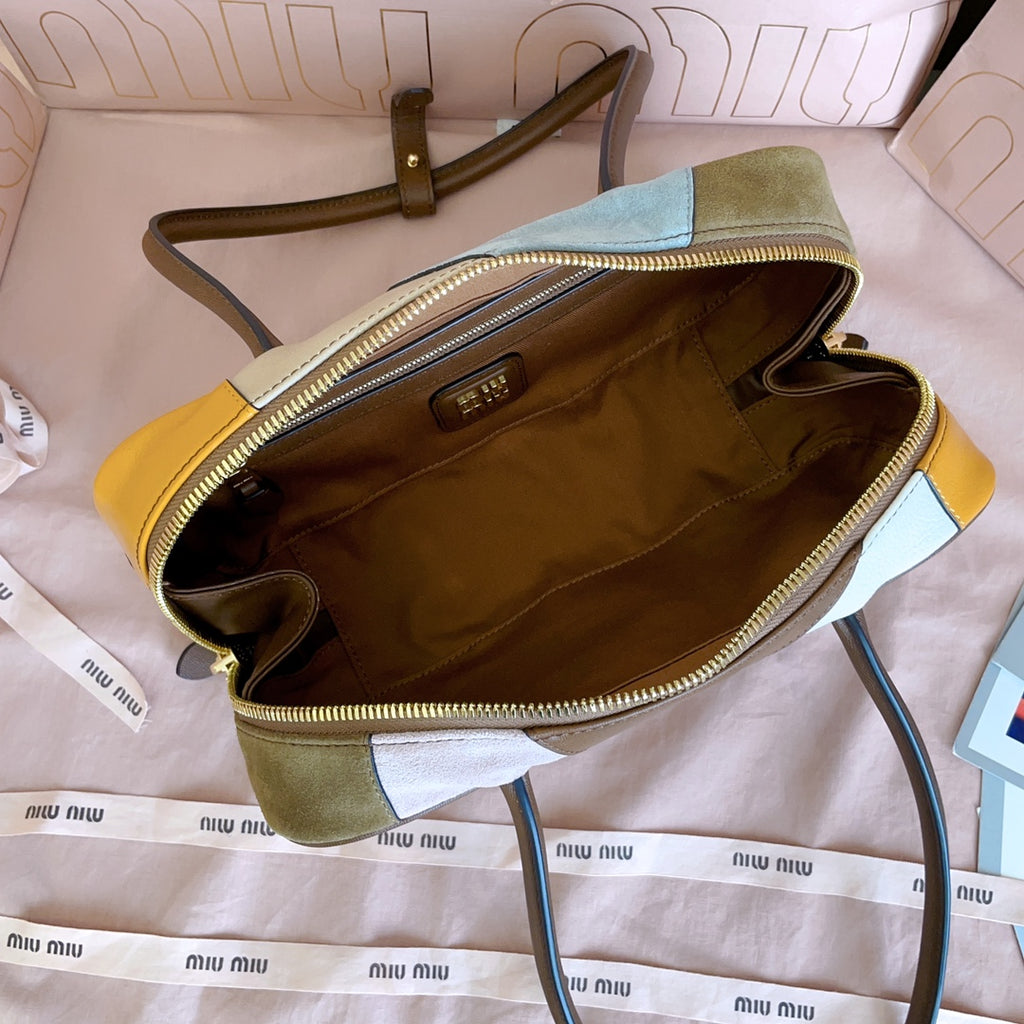 MiuMiu patchwork leather handbag interior view with gold zipper trim and front pocket