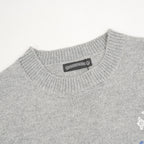 Heather gray knit sweater neckline with small brand label