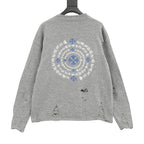 Heather gray long-sleeve knit sweater, back with large blue-and-white circular embroidery