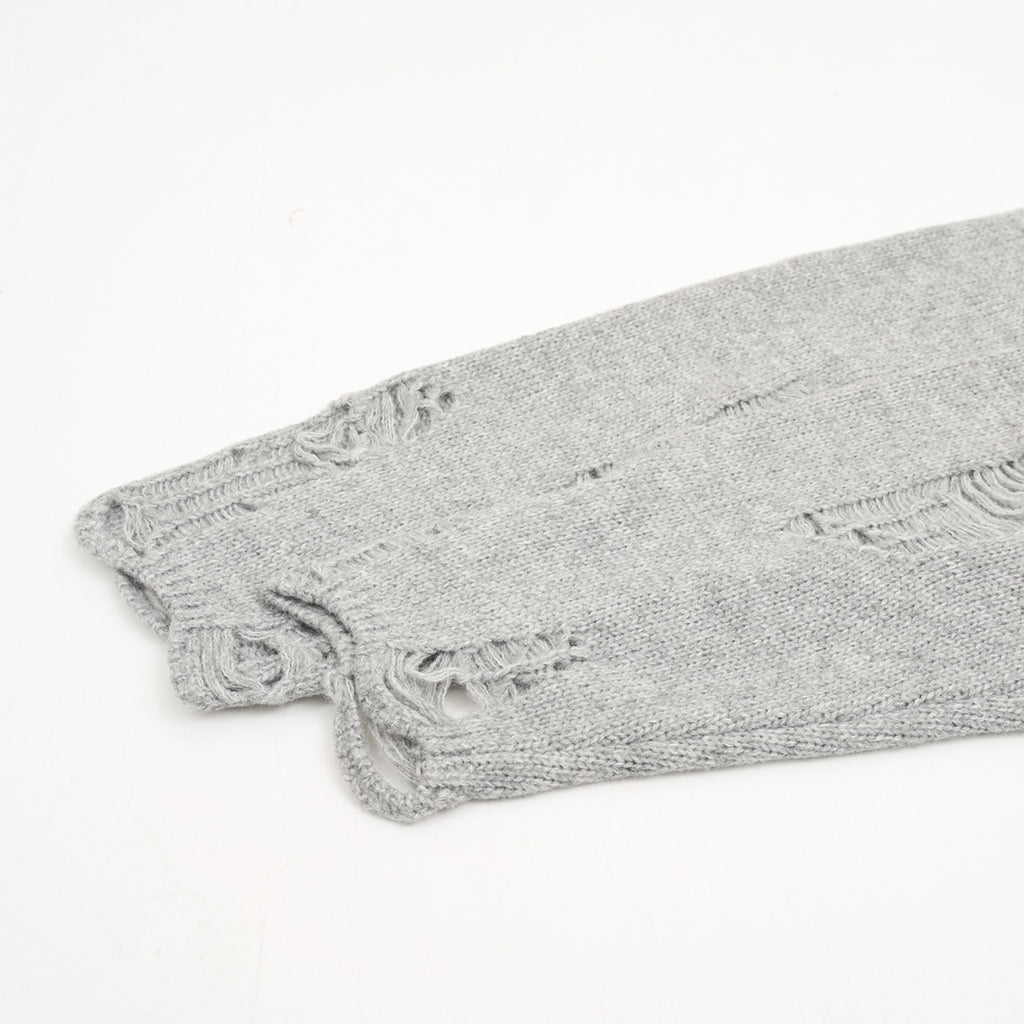 Heather gray knit sweater hem with frayed distressed detailing
