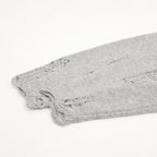 Heather gray knit sweater hem with frayed distressed detailing