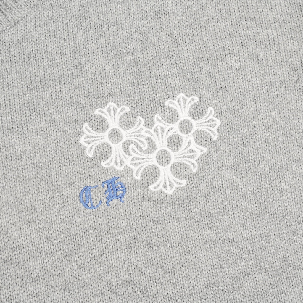 Heather gray knit sweater chest graphic with white snowflake-style embroidery and blue detail