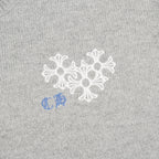 Heather gray knit sweater chest graphic with white snowflake-style embroidery and blue detail
