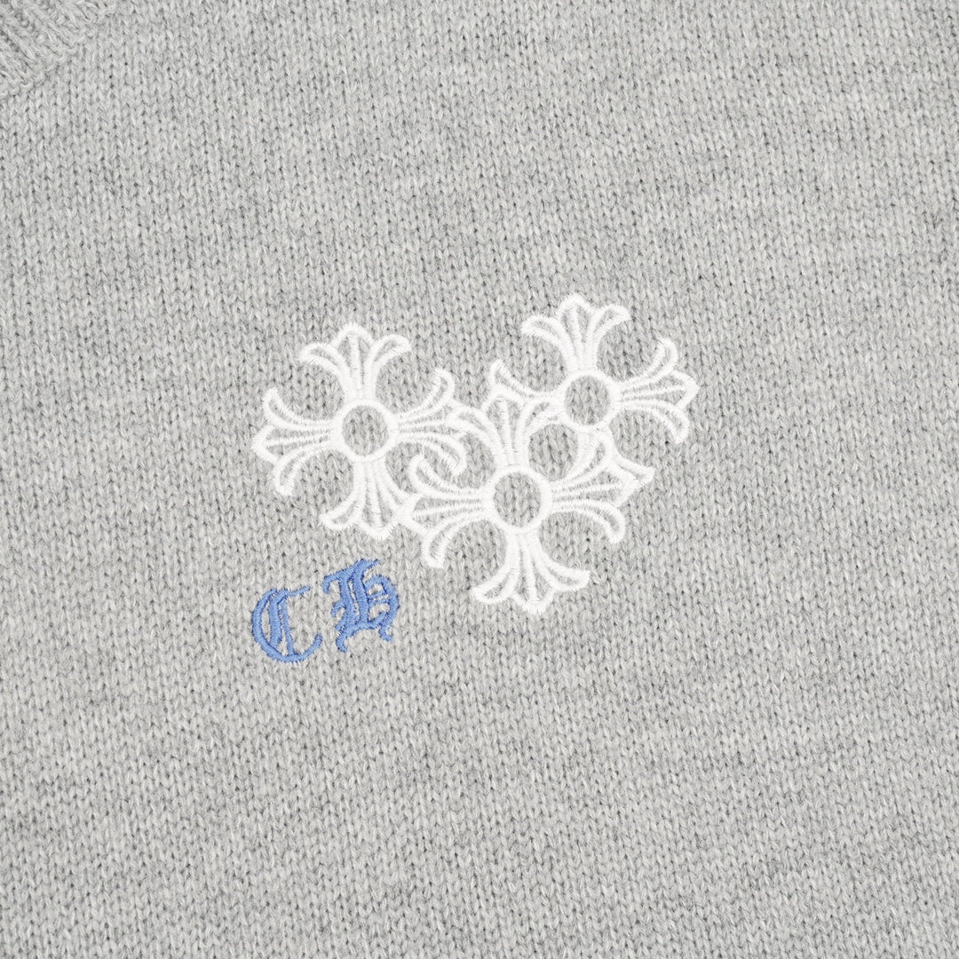 Heather gray knit sweater chest graphic with white snowflake-style embroidery and blue detail