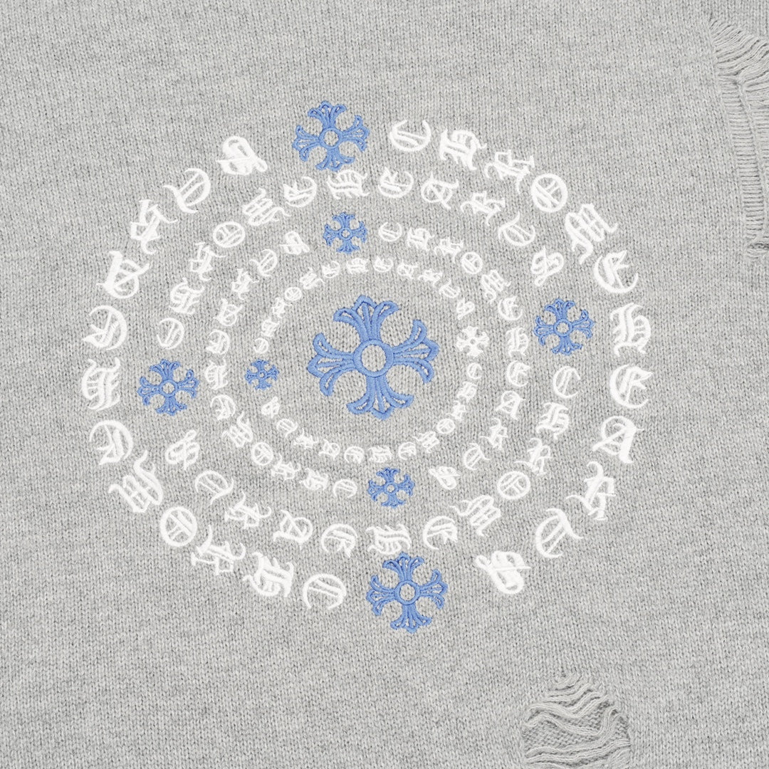 Heather gray sweater close-up of blue-and-white circular embroidered motif