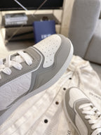 Dior unisex sneaker toe and side, perforations and gray overlay, white laces