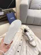 Sneaker outsole with tread pattern and Dior logo, with matching shoe in frame