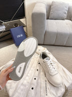 Dior unisex sneakers with visible outsole, white lace-up pair on display