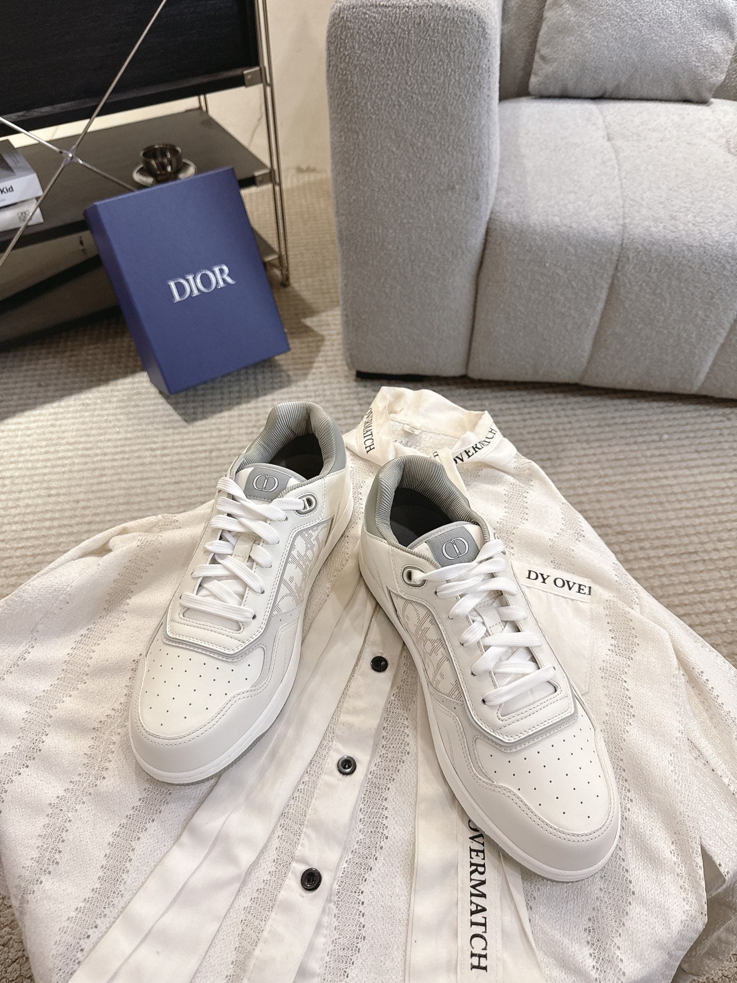 Dior unisex low-top sneakers pair, white with lace-up fronts and embroidered logos