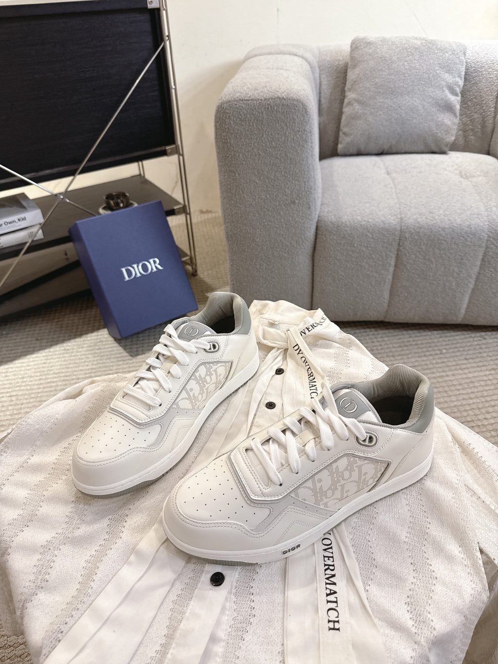 Dior unisex low-top sneakers pair, white leather with lace-up and side emblem print