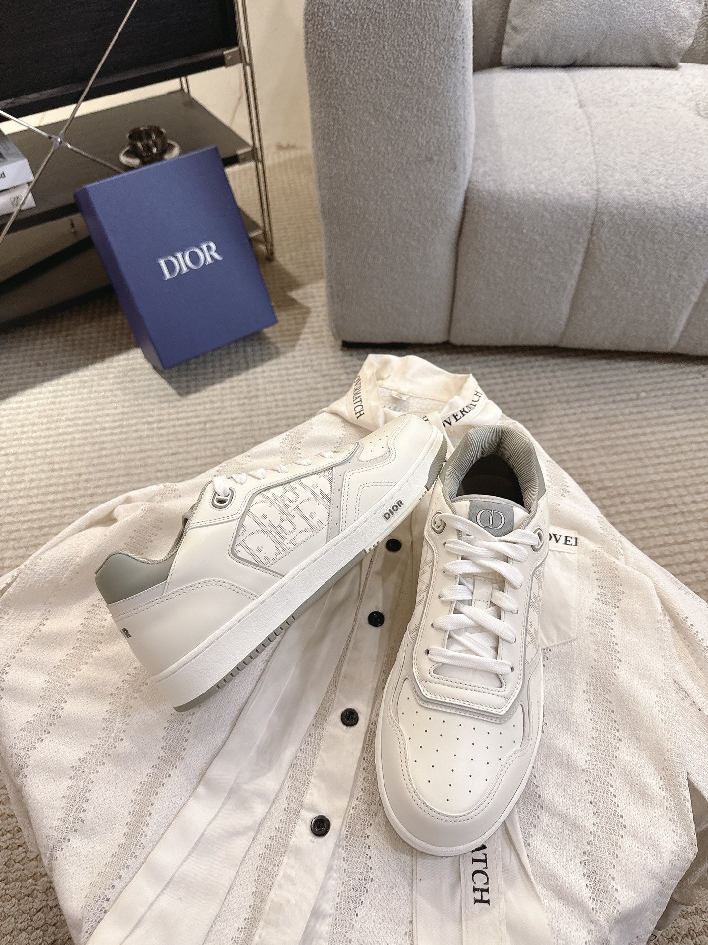 Dior unisex low-top sneakers pair, white leather with lace-ups and side script marks
