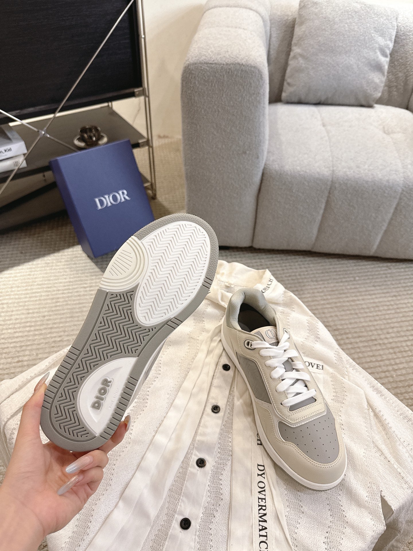 Sneaker outsole view with gray patterned tread and off-white upper
