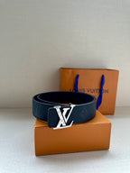 Louis Vuitton belt with dark blue embossed band and silver LV buckle