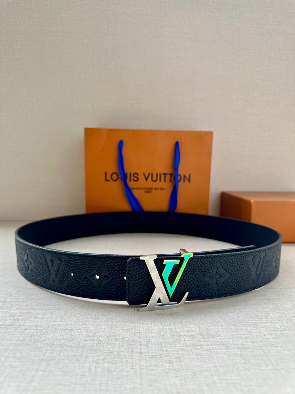 Louis Vuitton belt in dark blue embossed leather with large silver LV buckle