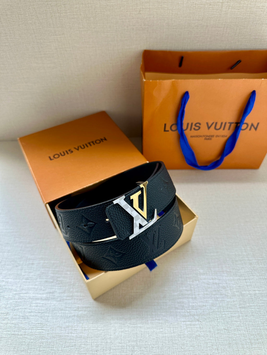 Louis Vuitton belt with dark blue embossed strap and silver LV buckle