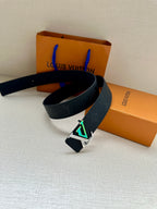 Louis Vuitton belt with dark blue strap and oversized silver LV buckle detail