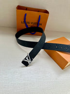 Louis Vuitton belt with dark blue strap and silver LV buckle, shown looped