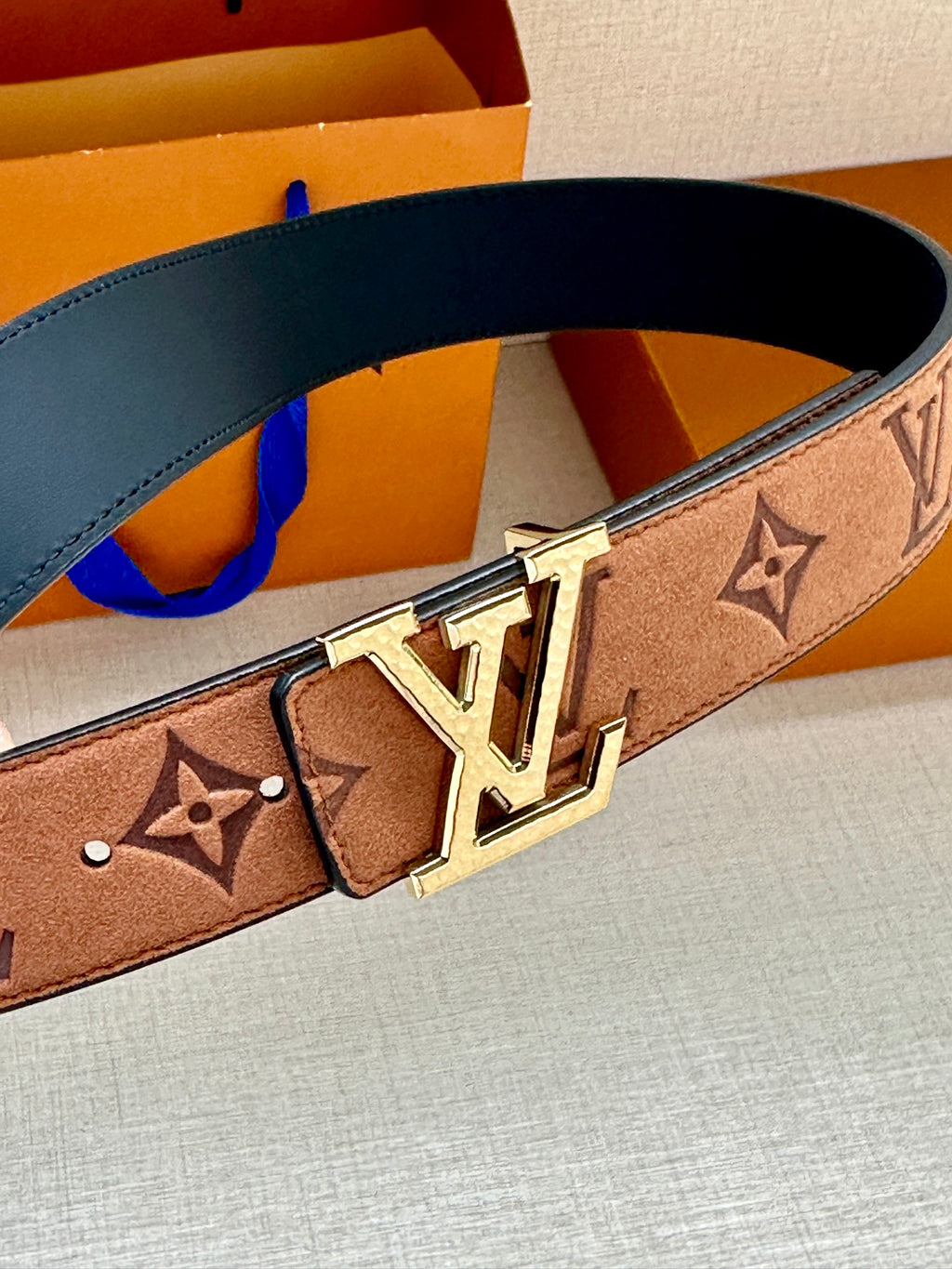 Louis Vuitton belt close-up: monogram canvas with gold-tone double-prong buckle