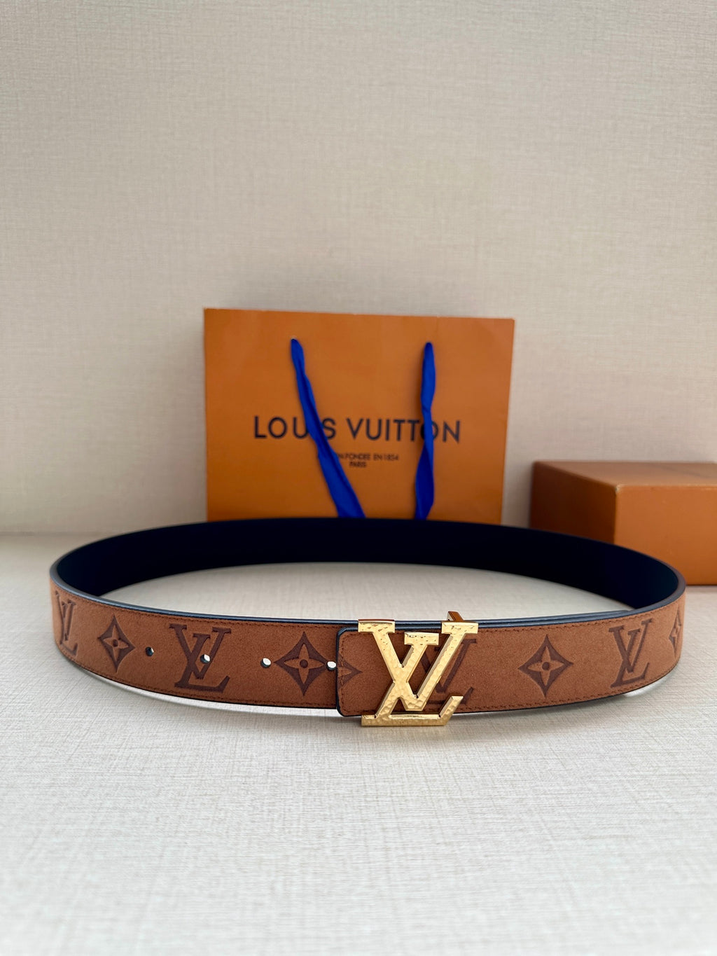 Louis Vuitton belt in dark brown with monogram pattern and gold-tone LV buckle