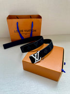 Monogram belt with dark blue strap and silver-tone buckle, laid with strap ends