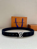 Monogram canvas belt with dark blue strap and silver-tone buckle, flat on surface
