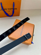 Monogram belt with dark blue strap and silver-tone buckle, belt laid diagonally