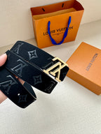 Monogram canvas belt close-up with metal buckle detail and dark blue strap